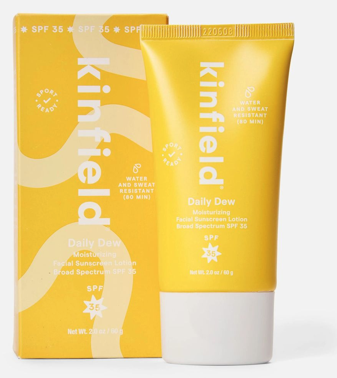 Kinfield Daily Dew SPF 35 facial sunscreen tube beside its yellow carton